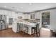 Modern kitchen featuring an island with seating, stainless steel appliances, and backyard view at 305 Rezzo St, Las Vegas, NV 89138