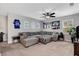 Bright and airy loft with a comfortable sectional sofa, ceiling fan, sports decor, and plenty of seating at 305 Rezzo St, Las Vegas, NV 89138