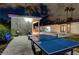 Backyard view featuring an outdoor dining space, lounge area, a ping pong table, and a pool at 3175 S Torrey Pines Dr, Las Vegas, NV 89146