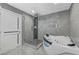 Modern bathroom features a glass shower, soaking tub, and stylish gray tile at 3175 S Torrey Pines Dr, Las Vegas, NV 89146