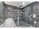 Bathroom showcases a glass shower, soaking tub, and modern gray tile for a spa-like feel at 3175 S Torrey Pines Dr, Las Vegas, NV 89146