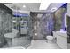 Spa-like bathroom with a glass-enclosed shower, modern toilet, and unique vanity lighting at 3175 S Torrey Pines Dr, Las Vegas, NV 89146