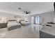 Expansive bedroom with tile floors, two beds, and a modern ceiling fan at 3175 S Torrey Pines Dr, Las Vegas, NV 89146