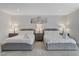Bright bedroom showcasing two beds, neutral décor, and sleek tile flooring at 3175 S Torrey Pines Dr, Las Vegas, NV 89146