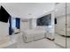 Modern bedroom featuring sleek white furniture, marble floors, and striking blue and gray accents at 3175 S Torrey Pines Dr, Las Vegas, NV 89146