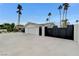 Side view of home showing a large garage with a big driveway, a well-maintained white exterior, and a black metal fence at 3175 S Torrey Pines Dr, Las Vegas, NV 89146