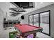 Game room featuring a pool table, bar, and sliding door access to the patio at 3175 S Torrey Pines Dr, Las Vegas, NV 89146