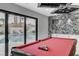 Pool table adjacent to the outside swimming pool with sliding door access and decorative wall at 3175 S Torrey Pines Dr, Las Vegas, NV 89146