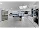 Modern kitchen featuring stainless steel appliances, white cabinetry, and an expansive center island at 3175 S Torrey Pines Dr, Las Vegas, NV 89146