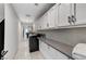 Well-lit laundry room with white cabinets, modern appliances, and ample counter space at 3175 S Torrey Pines Dr, Las Vegas, NV 89146