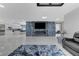 Spacious open-concept living room featuring a modern fireplace, tile floors, and an open kitchen with bar seating at 3175 S Torrey Pines Dr, Las Vegas, NV 89146