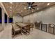 Elegant outdoor dining area featuring a full kitchen, grill, ceiling fan, and modern decor at 3175 S Torrey Pines Dr, Las Vegas, NV 89146