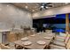 Covered outdoor kitchen and dining area offering modern appliances, ample seating, and views of the backyard pool at 3175 S Torrey Pines Dr, Las Vegas, NV 89146