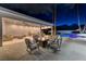 Inviting outdoor living space with modern seating around a fire pit overlooking the sparkling pool at 3175 S Torrey Pines Dr, Las Vegas, NV 89146