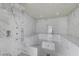 Luxurious walk-in shower featuring marble-style tile and multiple shower heads for a spa-like experience at 3175 S Torrey Pines Dr, Las Vegas, NV 89146