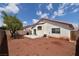 Expansive backyard featuring a concrete patio, block wall fencing, and mature landscaping at 343 Dune Ridge Ave, North Las Vegas, NV 89031