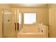 Bright bathroom featuring a tub with shower, and a bright window over the tub at 343 Dune Ridge Ave, North Las Vegas, NV 89031