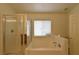 A bright bathroom features a separate shower and tub with natural light at 343 Dune Ridge Ave, North Las Vegas, NV 89031