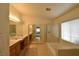 Bright bathroom with dual sinks, framed mirrors, soaking tub and a glass enclosed shower at 343 Dune Ridge Ave, North Las Vegas, NV 89031