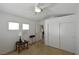Bright bedroom with a ceiling fan, carpet, and two windows at 343 Dune Ridge Ave, North Las Vegas, NV 89031