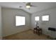 Bedroom featuring three windows, a ceiling fan, and a small table at 343 Dune Ridge Ave, North Las Vegas, NV 89031