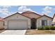 Charming single-story home featuring a red tile roof, neutral stucco, and a two car garage at 343 Dune Ridge Ave, North Las Vegas, NV 89031