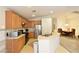 Bright kitchen with oak cabinets, stainless steel fridge, and adjacent dining area at 343 Dune Ridge Ave, North Las Vegas, NV 89031