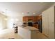 Well-equipped kitchen with stainless steel appliances, wooden cabinetry, and a functional island at 343 Dune Ridge Ave, North Las Vegas, NV 89031