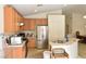 Kitchen area featuring stainless steel appliances, wood cabinets, and an island with a sink at 343 Dune Ridge Ave, North Las Vegas, NV 89031