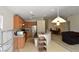 Bright kitchen area featuring stainless steel appliances, wood cabinets, and an island with sink at 343 Dune Ridge Ave, North Las Vegas, NV 89031