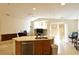Open living area with kitchen island, neutral walls, and plenty of natural light at 343 Dune Ridge Ave, North Las Vegas, NV 89031