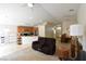 Bright, open-concept living room with neutral carpet and a kitchen in the background at 343 Dune Ridge Ave, North Las Vegas, NV 89031