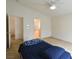 Spacious main bedroom with a ceiling fan, carpet flooring, and ensuite bathroom access at 343 Dune Ridge Ave, North Las Vegas, NV 89031
