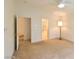Neutral bedroom with ceiling fan, leading to bathroom and dining area at 343 Dune Ridge Ave, North Las Vegas, NV 89031