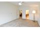 Neutral bedroom with ceiling fan, leading to bathroom and dining area at 343 Dune Ridge Ave, North Las Vegas, NV 89031