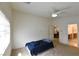 Main bedroom with window, ceiling fan, carpet flooring, and ensuite bathroom access at 343 Dune Ridge Ave, North Las Vegas, NV 89031