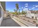 A large balcony with decorative railings offers views of a neighborhood with pools and palm trees at 3552 Coventry Gardens Dr, Las Vegas, NV 89135