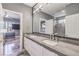Elegant bathroom with a double vanity, modern lighting, and a door leading to the shower room at 3552 Coventry Gardens Dr, Las Vegas, NV 89135