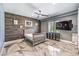 A cozy bedroom featuring a modern accent wall and a large window with blinds at 3552 Coventry Gardens Dr, Las Vegas, NV 89135