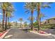Gated community entrance lined with palm trees and colorful flowerbeds at 3552 Coventry Gardens Dr, Las Vegas, NV 89135