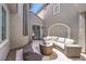 Inviting courtyard with comfortable wicker seating, a fire pit, and an entry door at 3552 Coventry Gardens Dr, Las Vegas, NV 89135