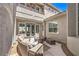 Relaxing courtyard with wicker seating, a fire pit, and access to the home's interior at 3552 Coventry Gardens Dr, Las Vegas, NV 89135