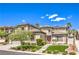 Beautiful two-story home with turret entrance, shutters, mature trees and manicured lawn at 3552 Coventry Gardens Dr, Las Vegas, NV 89135