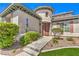 Charming home featuring a unique turret entrance, complemented by mature landscaping and a well-manicured lawn at 3552 Coventry Gardens Dr, Las Vegas, NV 89135