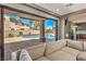Open living room view to backyard pool through sliding glass doors, enhancing indoor/outdoor living at 3552 Coventry Gardens Dr, Las Vegas, NV 89135