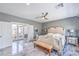 Spacious bedroom features seating, balcony access, and ceiling fan at 3552 Coventry Gardens Dr, Las Vegas, NV 89135
