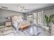 Bright main bedroom boasts balcony access, ceiling fan, and marble floors at 3552 Coventry Gardens Dr, Las Vegas, NV 89135