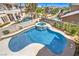 Aerial view of a backyard featuring a sparkling pool, spa, and well-manicured landscaping at 3552 Coventry Gardens Dr, Las Vegas, NV 89135