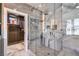 Modern shower with decorative lighting, shower niche, and glass doors at 3552 Coventry Gardens Dr, Las Vegas, NV 89135