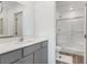 Modern bathroom with gray vanity, white countertops, and glass shower doors at 3585 Arcadian Sea St, Las Vegas, NV 89106